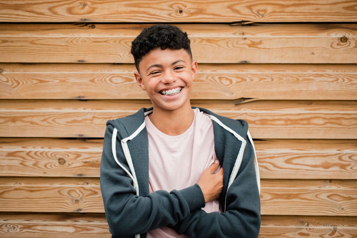 young teen boy with braces, smiling