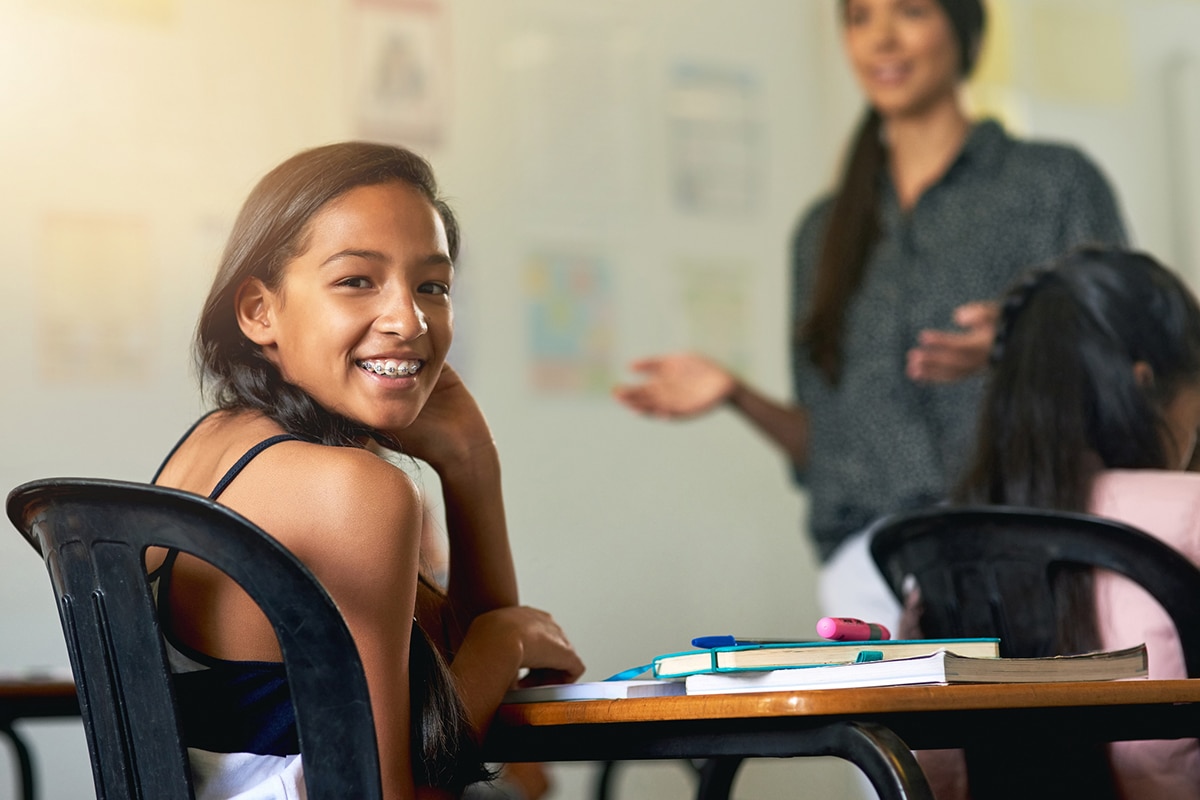 girl with braces smiling in classroom